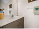 Half bathroom featuring a white marble sink, wood cabinets and neutral paint tones at 194 Sunset Rd, Rotonda West, FL 33947