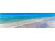 A beach view showing the ocean waves washing ashore onto the sand at 194 Sunset Rd, Rotonda West, FL 33947