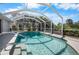 Inviting in-ground pool inside screened lanai with lush tropical landscaping for added privacy and enjoyment at 194 Sunset Rd, Rotonda West, FL 33947