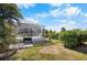 Exterior view of the lanai with sparkling pool surrounded by beautiful landscaping at 194 Sunset Rd, Rotonda West, FL 33947