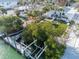 Aerial view showcasing waterfront property with a private dock, backyard, and serene canal setting at 205 Sand Dollar Ln, Englewood, FL 34223