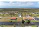 This aerial view shows properties with pools and lush landscaping within a serene residential neighborhood at 237 W Pine Valley Ln, Rotonda West, FL 33947