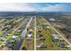 This aerial view shows a home centrally located in a planned community, with golf courses and natural waterways at 237 W Pine Valley Ln, Rotonda West, FL 33947
