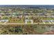 Wide aerial shot showcasing the layout of homes in a community surrounded by waterways and greenery at 237 W Pine Valley Ln, Rotonda West, FL 33947