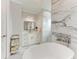 Elegant bathroom featuring marble accents, a soaking tub, and a stylish vanity at 237 W Pine Valley Ln, Rotonda West, FL 33947