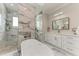 A luxurious bathroom with a modern freestanding tub, dual vanities, and a glass-enclosed shower at 237 W Pine Valley Ln, Rotonda West, FL 33947