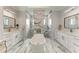 Bright bathroom showcasing a modern freestanding tub, marble accents, and dual vanities at 237 W Pine Valley Ln, Rotonda West, FL 33947