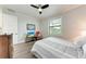 Relaxing bedroom offers a cozy bed, TV, and a ceiling fan, ideal for unwinding after a long day at 237 W Pine Valley Ln, Rotonda West, FL 33947