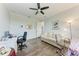 Inviting bedroom features a couch, desk setup, and a ceiling fan for a relaxing ambiance at 237 W Pine Valley Ln, Rotonda West, FL 33947