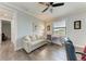 Cozy bedroom showcasing a comfortable couch, desk by the window, and a modern ceiling fan at 237 W Pine Valley Ln, Rotonda West, FL 33947