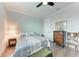 Serene bedroom features a soft bed, dresser, and a ceiling fan creating a peaceful atmosphere at 237 W Pine Valley Ln, Rotonda West, FL 33947