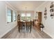 Dining room with wood table, chairs, decorative lighting, and windows providing natural light at 237 W Pine Valley Ln, Rotonda West, FL 33947