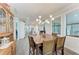 Spacious dining area with a large wooden table, contemporary lighting, and bright windows at 237 W Pine Valley Ln, Rotonda West, FL 33947
