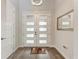 Inviting foyer features a white front door with decorative glass panels and wood-look flooring at 237 W Pine Valley Ln, Rotonda West, FL 33947