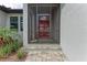 Screened in front door with a patriotic American flag hanging on the door at 237 W Pine Valley Ln, Rotonda West, FL 33947