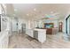 Open kitchen features a center island with seating, stainless steel appliances, and a modern design at 237 W Pine Valley Ln, Rotonda West, FL 33947
