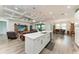 Open-concept kitchen with white cabinets, island, modern appliances, and views of the dining and living areas at 237 W Pine Valley Ln, Rotonda West, FL 33947
