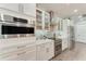 Gourmet kitchen features stainless steel appliances, custom cabinetry, and modern backsplash at 237 W Pine Valley Ln, Rotonda West, FL 33947