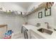 Well-organized laundry room with modern appliances, a sink, and ample shelving at 237 W Pine Valley Ln, Rotonda West, FL 33947