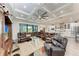 Expansive living room features coffered ceilings, recessed lighting, and sliding glass doors to the lanai at 237 W Pine Valley Ln, Rotonda West, FL 33947