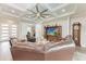 Bright living room showcasing tray ceilings, recessed lights, stylish furniture, and modern decor at 237 W Pine Valley Ln, Rotonda West, FL 33947