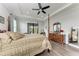 Well-lit main bedroom features a four-poster bed, tray ceiling, and outdoor views at 237 W Pine Valley Ln, Rotonda West, FL 33947