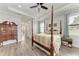 Bright main bedroom boasts a four-poster bed, tray ceiling, and an ensuite bathroom at 237 W Pine Valley Ln, Rotonda West, FL 33947