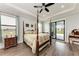 Spacious main bedroom boasts a four-poster bed, tray ceiling, and access to an outdoor patio at 237 W Pine Valley Ln, Rotonda West, FL 33947