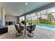 Screened patio with outdoor furniture offering views of the pool and backyard at 237 W Pine Valley Ln, Rotonda West, FL 33947