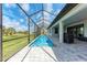 The screened-in pool offers privacy and protection from the elements while overlooking a lush green landscape at 237 W Pine Valley Ln, Rotonda West, FL 33947