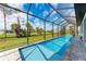 Relax in this screened pool with an expansive green view, offering a serene retreat at 237 W Pine Valley Ln, Rotonda West, FL 33947