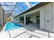 This screened-in pool is adjacent to the house under a covered lanai with outdoor shower for convenience at 237 W Pine Valley Ln, Rotonda West, FL 33947