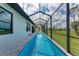 A screened-in pool stretches along the back of the house, inviting refreshing swims and relaxation at 237 W Pine Valley Ln, Rotonda West, FL 33947
