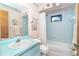 Light blue bathroom with updated vanity, bathtub, and decor accents at 2948 Briant St, North Port, FL 34287