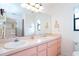 Bright bathroom featuring a double sink vanity and large mirror at 2948 Briant St, North Port, FL 34287