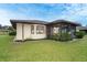 Back of house featuring manicured lawn and screened-in patio at 2948 Briant St, North Port, FL 34287