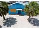 Aerial exterior view of a blue beach house, showcasing palm trees at 40 Sand Dollar Ln, Englewood, FL 34223