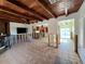 Spacious living room with exposed wood beams and tile flooring, ready for renovation at 40 Sand Dollar Ln, Englewood, FL 34223