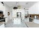 Stylish kitchen with white cabinetry, an island with open shelving, and stainless steel appliances at 42 Medalist Ln, Rotonda West, FL 33947