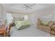 A serene main bedroom features a king bed, sitting area, and tray ceiling at 42 Medalist Ln, Rotonda West, FL 33947