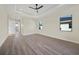 Bright bedroom featuring a ceiling fan, two windows and wood-look floors at 443 Boundary Blvd, Rotonda West, FL 33947