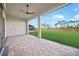 A covered patio with brick pavers offers outdoor living space and views of the grassy backyard at 443 Boundary Blvd, Rotonda West, FL 33947