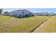 Lawn view of property showing nice grass and limited landscaping at 5703 Holiday Park Blvd, North Port, FL 34287