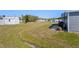 Spacious backyard featuring green grass and a storage shed at 5703 Holiday Park Blvd, North Port, FL 34287