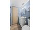 Compact bathroom with white vanity, wood-look floors, and modern lighting at 5703 Holiday Park Blvd, North Port, FL 34287