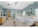 Serene bedroom with a queen-size bed, mirrored closet doors, and ensuite bathroom at 5703 Holiday Park Blvd, North Port, FL 34287