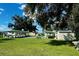 Exterior bocce ball court with a seating area under a covered awning at 5703 Holiday Park Blvd, North Port, FL 34287