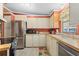 Well-lit kitchen with stainless steel appliances and a view of the neighborhood outside at 5703 Holiday Park Blvd, North Port, FL 34287