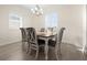 Dining area with a chandelier, natural light, and modern wood flooring at 677 Barnacle Ct, Englewood, FL 34223