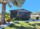 Charming screened-in porch with manicured landscaping, complemented by a carport at 810 Manchester Ct, Englewood, FL 34223